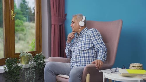 Adult Listening to Music in Chair Indoors