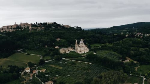 Aerial view of Italy's green countryside on an overcast day.