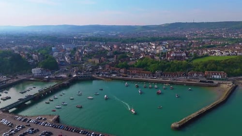 Aerial tracking view, trawler transportation, town seaside scenery