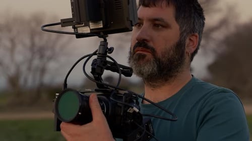 Man Holding Professional Digital Video Camera Outdoors