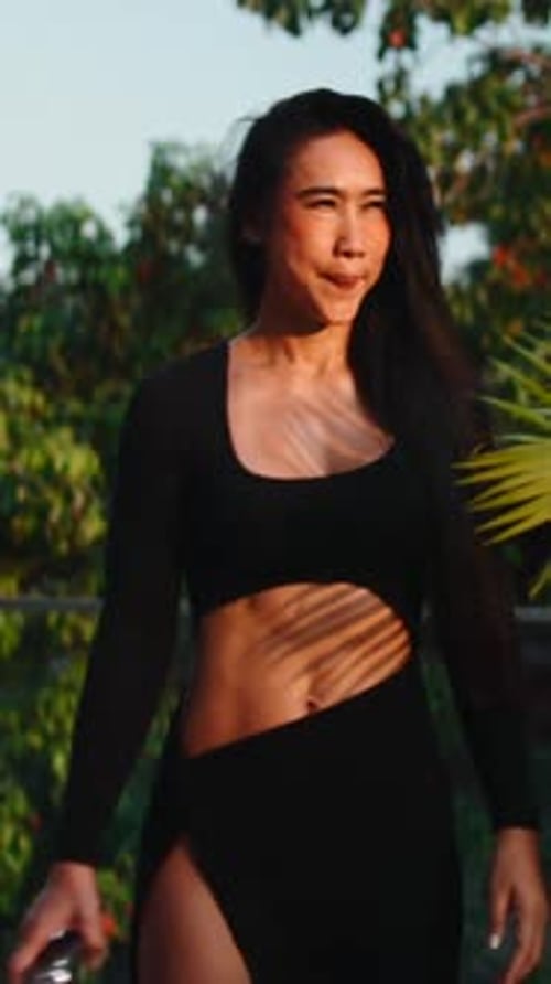 Woman in Black Outfit Walks Towards Camera