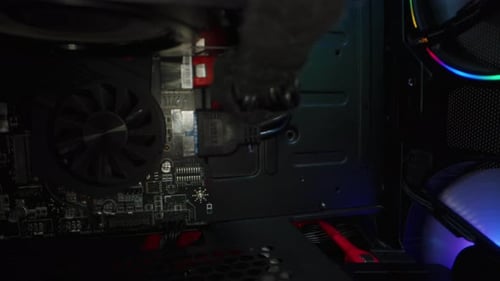 Motherboard inside a working computer system unit with RGB lit coolers. Slider, macro.