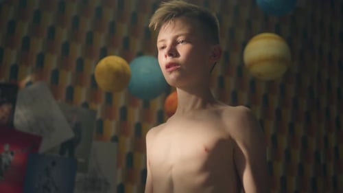 Teenage Boy Works Out in His Room Lifts Dumbbells Bare Upper Body Biceps Curls