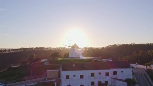 Aerial view of traditional village with windmill at sunrise, Odeceixe, Portugal.