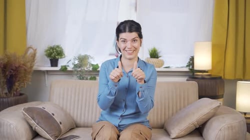 Enthusiastic Woman Gives Two Thumbs Up, Claps