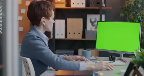 Businesswoman Using Computer Typing Looking at Chroma Key Green Screen Focused on Online Business
