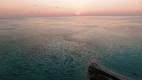 sand bank maldivian beach at sunset
