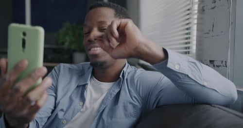 Man Chatting on Phone Video Call at Home