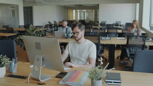 Man Working on Computer in Open Space Office