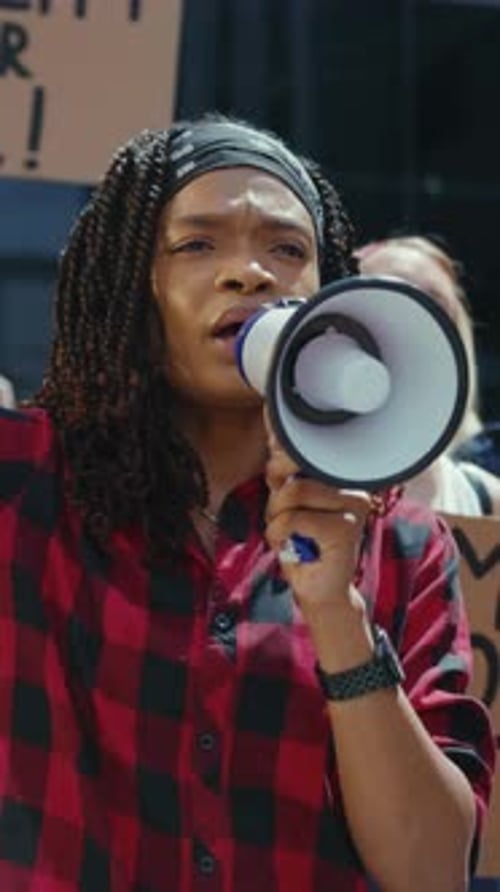 Woman Speaking into Megaphone at Outdoor Demonstration