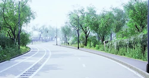 Winding Road Curves Through a Serene Green Landscape in Bright Daylight