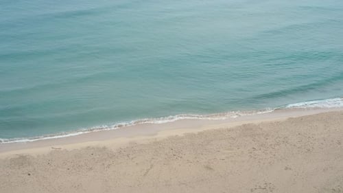 Sea waves and beach aerial view, natural background.