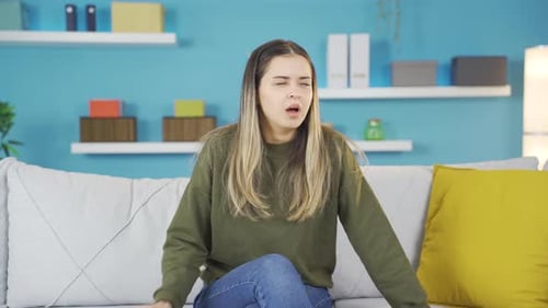 Woman Coughing While Sitting on Couch Indoors
