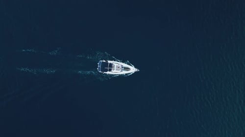 Topdown View of a Sailing Yacht in the Center of the Frame Sailing in the Sea
