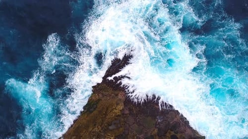 Aerial View Powerful Ocean Waves Crash Against Dark Coastal Rocks