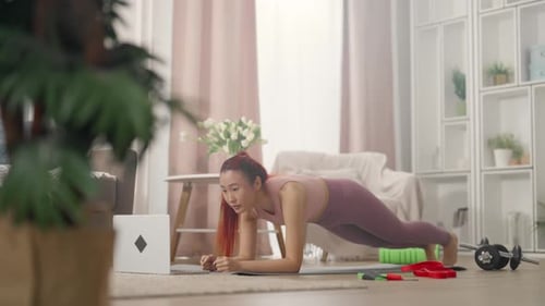 Woman Does Plank Workout in Bright Home