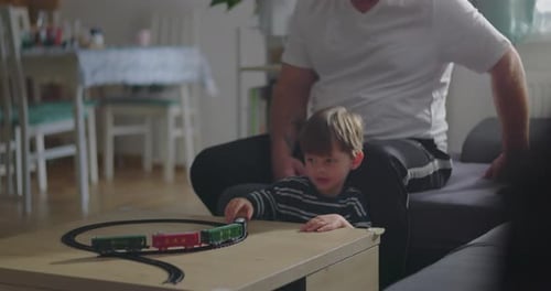 Family Playing with Toy Train at Home