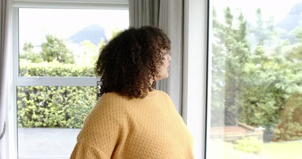 Woman Standing at Window Looking Outside on Bright Day, Sports Stock ...