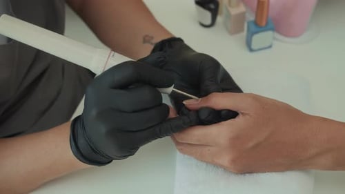 Nail Technician Filing Client's Nails Close Up