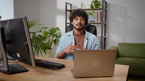 Young Adult On Video Call at Desk