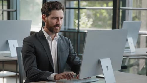 Successful Adult Bearded Freelancer Worker Man at Office Working Typing Laptop Smiling at Camera