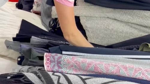 Used Clothes on Hangers in a Store A Big Pile of Old Useless Clothes Fashion Vertical Video