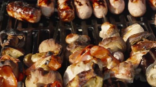 Assorted Meats and Vegetables Cooking on Grill