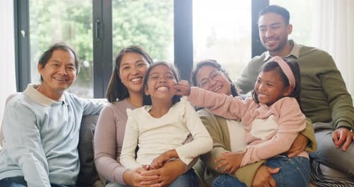 Happy Multi-Generational Family Smiles Together At Home
