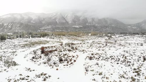 Winterscape Snow Covered Field And Rocky Mountains Range Near Estes Park, Colorado USA. 4K Drone. Ca