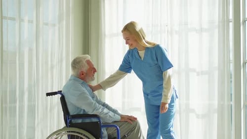 Smiling Nurse Caring for Senior Patient in Wheelchair