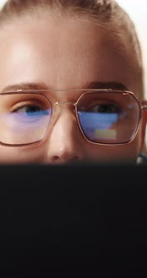 Woman Wearing Glasses Working on a Tablet
