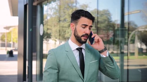 Slow Motion Fotage of One Business Man Walking and Talking By Mobile Phone Executive Male Having a