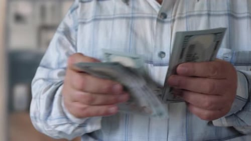 Senior Man Counts Money