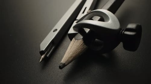 Architectural Drafting Compass and Pencil in Dramatic Lighting