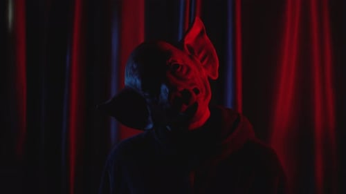 Menacing Pig Mask in Dark Red and Blue Lighting