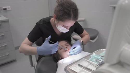 Dentist Examining Child Patient in Modern Office