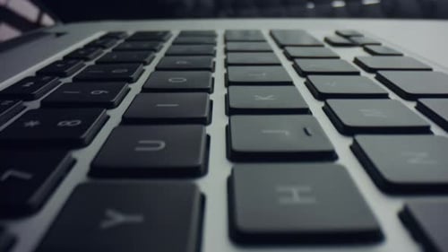 Closeup Grey Laptop Computer with Black Keyboard. Macro View of Modern Black