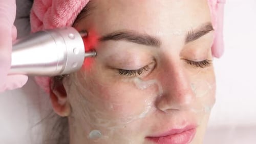 Woman Receiving a Red Light Facial Treatment