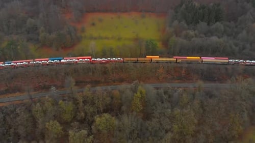 Aerial View of Freight Train Transporting New Cars
