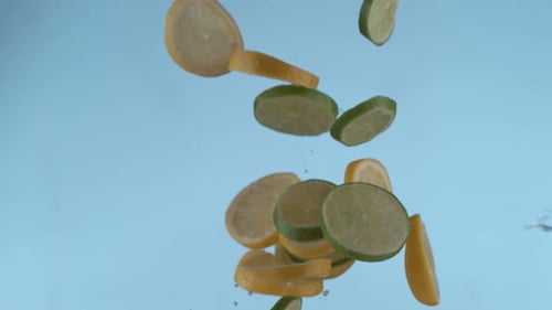 Fresh Lemon and Lime Slices Falling with Splashing Water