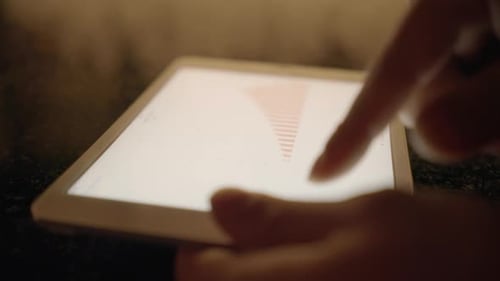 Fingers Using Tablet Device to Review Data Charts