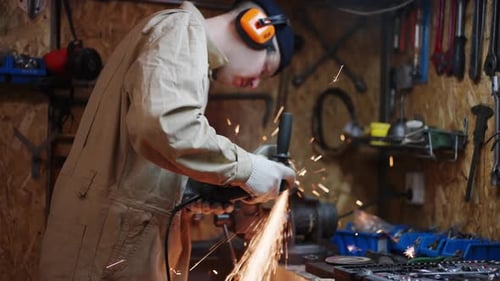 Worker Cutting Metal Tube Using an Angle Grinder Bright Sparks and Flashes
