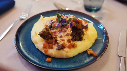 Gourmet Dish with Mashed Potatoes, Meat, and Vegetables