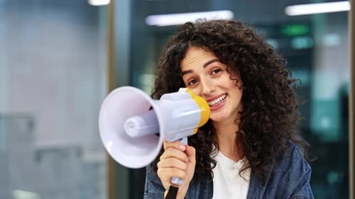 Woman Making Announcement with Megaphone in Office