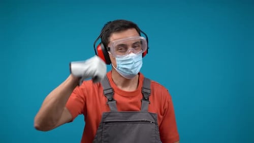 Man in Safety Gear Gives Thumbs Up