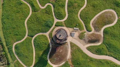 a wooden tower in the center of the park looking down.