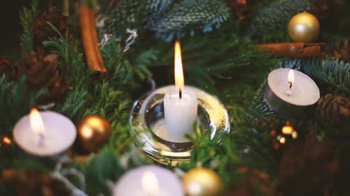 Candles and Christmas Ornaments on a Fir Branch