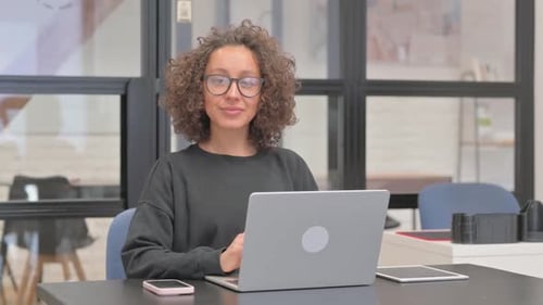 Woman Working on Laptop in Bright Office