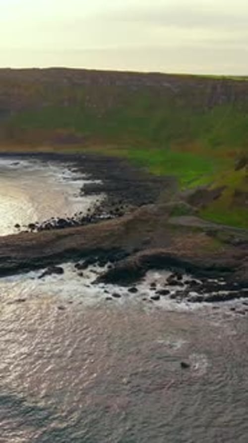 Wide social ratio aerial reveal video of The Giant's Causeway in Bushmills, Northern Ireland