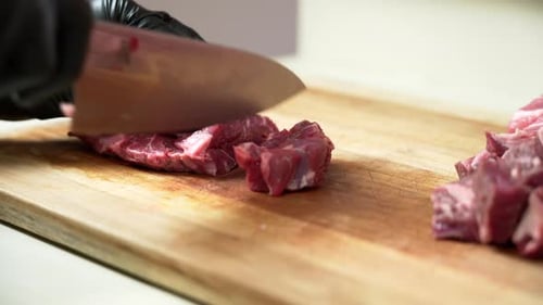 Cutting Raw Meat on Wooden Cutting Board